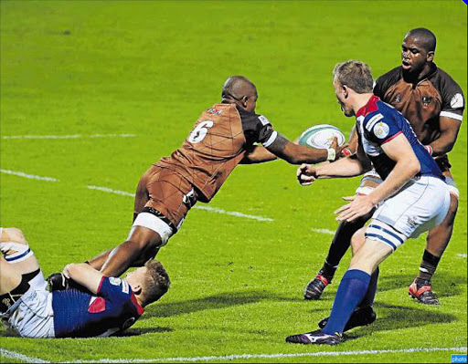 MOVING THE BALL: Onke Dubase, the Border Bulldogs flank, left, passes the ball to teammate Siya Mdaka during their game against the Welwitchias from Namibia in East London on Friday. The home team won 61-7 Picture: SINO MAJANGAZA