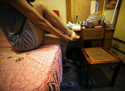A legal prostitute Miko poses for a photo inside a brothel converted into a museum in Taipei.