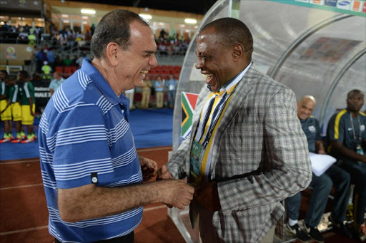 A file photo of then South Africa's coach Ephraim Mashaba (R) sharing a laugh with Ghana's coach Avram Grant (L) during the 2015 African Cup of Nations group C football match between South Africa and Ghana in Mongomo on January 27, 2015.