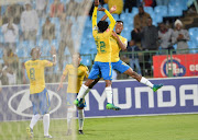 Mamelodi Sundowns players Hlompho Kekana, Gaston Sirino, Percy Tau and Themba Zwane celebrate after scoring a goal. 