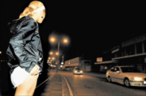 HIGH PRIESTESS: A streetwalker waits for customers. Author Futhi Ntshingila's fictional prostitute thinks of herself as a healer. Pic: FREDLIN ADRIAAN. 21/04/07. © Weekend Post.\n\nMAKING A LIVING: A prostitute stands on the side of Central's Goven Mbeki Avenue hoping to lure another client. A DANGEROUS ROAD: The 2010 Soccer World Cup will boost demand in the sex industry, and with SA's rampant unemployment, many women will turn to prostitution. The Weekender. 09/05/2009. Pg 04. ------ mainbody weekpics colour 30cm wide johan 5239