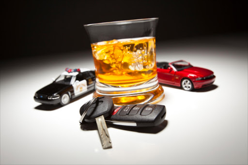 Police and sports car next to alcoholic drink with key