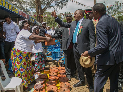 President Uhuru Kenyatta visiting a stall at the Agricultural Society of Kenya Nairobi International Trade Fair at the Jamhuri Park Showground on October 5, 2016. /PSCU