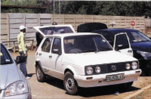 GOING, GOING GONE: Tiny Makopo, former matron of the Oprah Winfrey Academy for Girls in Meyerton had her car seized by debt collectors outside court yesterday. She has not paid instalments since May. Pic. Unknown.