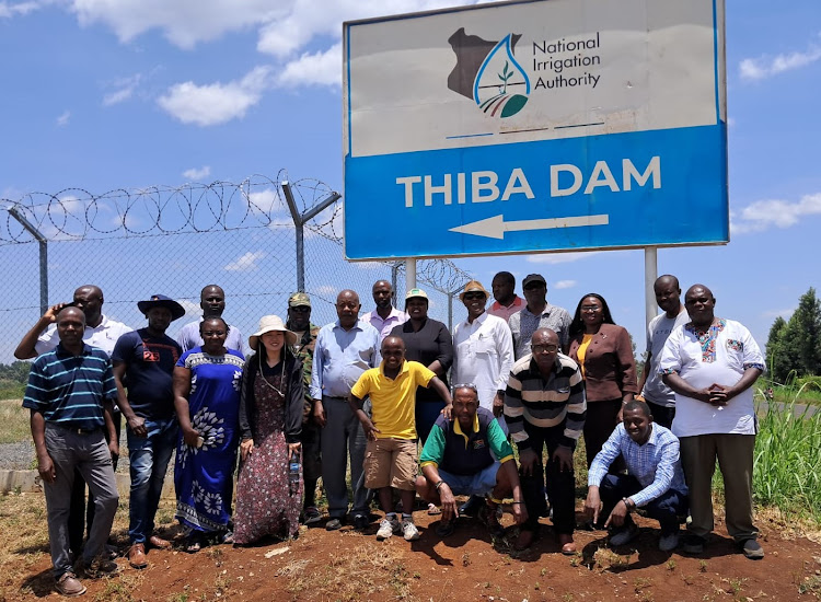 Kenya-Japan Alumni Association (KEJAA) Members pose for a photo after touring Thiba Dam.