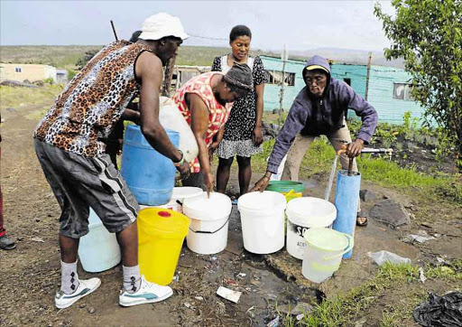 Residents of Zizamele and other nearby townships in Butterworth collect water from a communal tap at the Zizamele shack settlement as taps have run dry in town. Picture: SILUSAPHO NYANDA