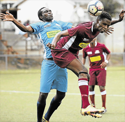 AIRBORNE TUSSLE: FC Buffalo’s Ishmael Madimabe and EC Bees’ Simphiwe Dlamini go after the ball during their Nedbank Cup knockout encounter at North End Stadium on Saturday Picture: MARK ANDREWS