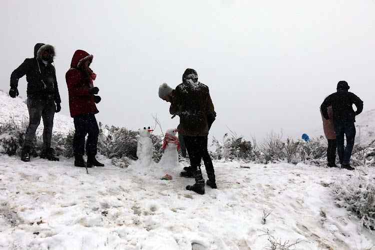 Locals enjoy the snowfall on the Swaarmoed Pass 10km outside Ceres in the Western Cape.