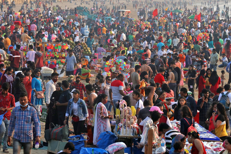 People visit Juhu beach during the ongoing coronavirus disease (COVID-19) pandemic, in Mumbai, India, December 25, 2021. The country has imposed ight curfews have been imposed in all major cities and restaurants ordered to limit customers ahead of new year's even.