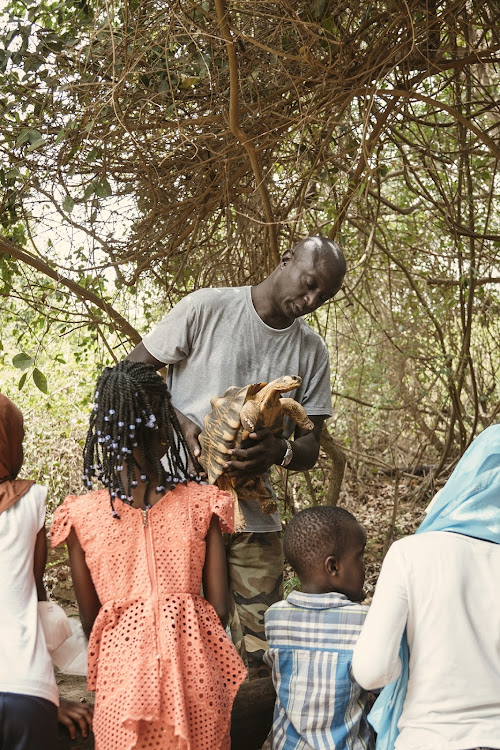 Part of Tomas Diagne's conservation work involves educating people about why tortoises are so important and thus worth protecting. Picture: SUPPLIED/ROLEX