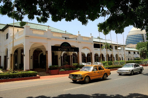 Sudanese drive past the Grand Holiday Villa hotel in the Sudan's capital Khartoum on October 20, 2012. File photo.