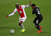 Ajax Cape Town striker Tendai Ndoro (L) shields the ball away from Happy Jele of Orlando Pirates during the Absa Premiership match at at Cape Town Stadium, Cape Town on 31 January 2018.