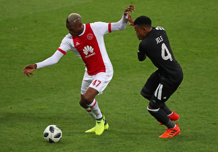 Ajax Cape Town striker Tendai Ndoro (L) shields the ball away from Happy Jele of Orlando Pirates during the Absa Premiership match at at Cape Town Stadium, Cape Town on 31 January 2018.