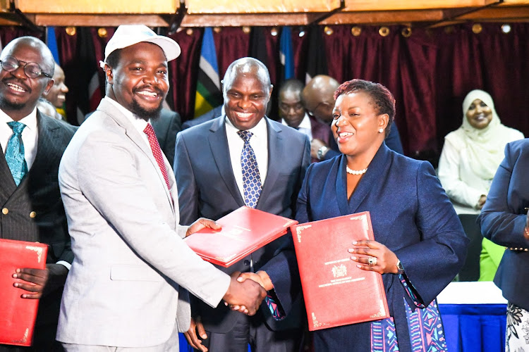 KMPDU Secretary General Davji Atellah with Health CS Susan Nakhumicha after signing an agreement to end the doctors's strike on May 8, 2024