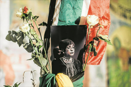 DIGNIFIED: A photograph of Winnie Madikizela-Mandela surrounded by the South African and ANC flags at the Old Durban Prison’s Human Rights wall as mourners gather to pay their respects during a candlelight vigil in Durban Picture: AFP