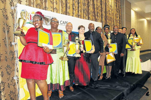 WINNING SMILES: Eastern Cape education SG Themba Kojana (fifth from the left) with teachers during the National Teaching Awards provincial ceremony at East London’s Osner Hotel held earlier this week Picture: MICHAEL PINYANA