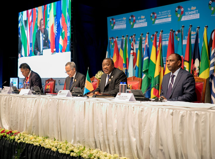 Outgoing ACP secretary general Patrick Gomes, Kenya and incoming ACP President Uhuru Kenyatta and acting Treasury and Planning CS Ukur Yatani at the closing ceremony of the 9th ACP Summit at KICC, Nairobi, on December 10