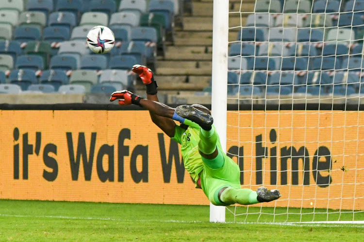 Denis Onyango of Mamelodi Sundowns makes a save during his side's penalty shootout against Cape Town City in the MTN8 final at Moses Mabhida Stadium on October 30 2021 in Durban.