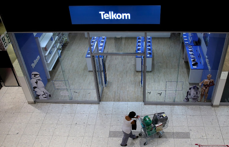A shopper walks past a Telkom shop at a mall in Johannesburg.