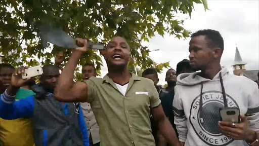 Foreigners in a tense standoff with organisers of a protest against foreign nationals in Pretoria on 24 February 2017.