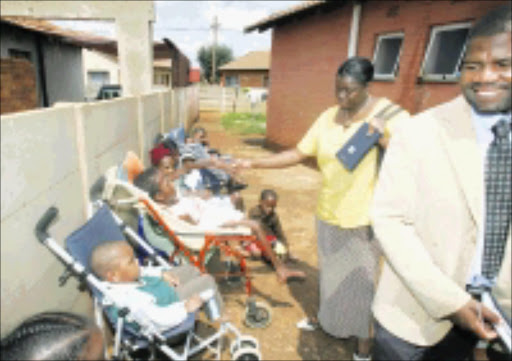 KIND GESTURE: Phetogo Montsha, Botswana's vice-consul administration, and Tireco Balekile, vice-consul immigration, visit Mohau's Orphans and Disabled Home 17/03/09. Pic. Veli Nhlapo. © Sowetan.