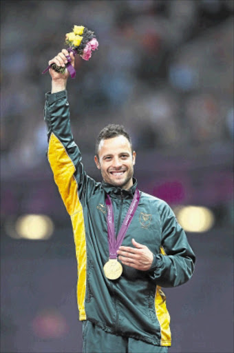 SYMBOL: Gold medallist Oscar Pistorius poses on the podium during the medal ceremony for the men's 400m T44 final at the London 2012 Paralympic Games. Photo: Getty Images