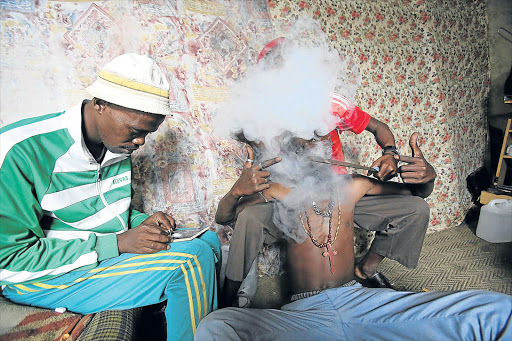 A TEMPORARY HIGH: Wrong, Ndoda and Chester, members of one of the gangs that have terrorised the community of Duncan Village Picture: MARK ANDREWS