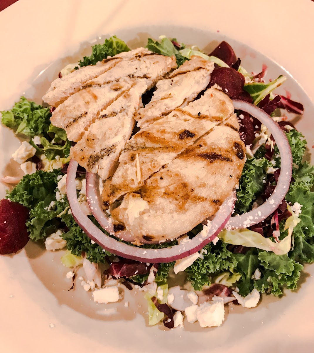 Superfood salad with beets, kale, red onion & grilled chicken.