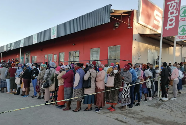 Social grant beneficiaries from the surrounding villages of Mqanduli in the Eastern Cape flock to Mqanduli town to access their grants .