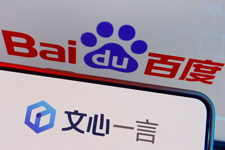 The logo of Baidu's AI chatbot Ernie Bot is displayed near a screen showing the Baidu logo in this illustration.