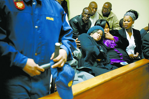 Andries Tatane ’s widow, Rose, (left) is comforted by friends at the Ficksburg Magistrate’s Court. File photo.