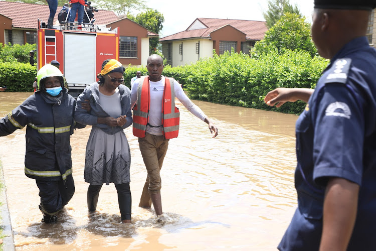 Personnel from the emergency response unit evacuate people from a flooded residential estate in Athi River, Machakos on April 24, 2024.