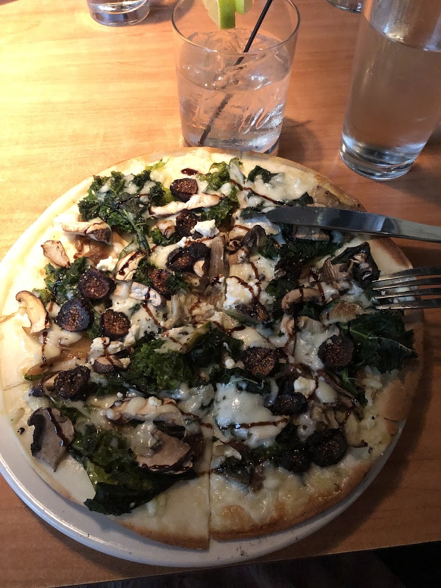 The Woodlands Pizza with figs, carmelized onions, mushrooms, and kale.