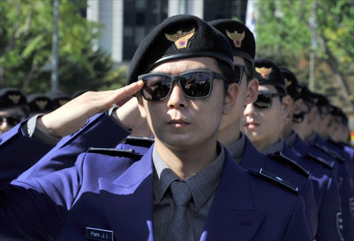 South Korean "tourist police" officers salute during their inauguration ceremony at Gwanghwamun square in Seoul.