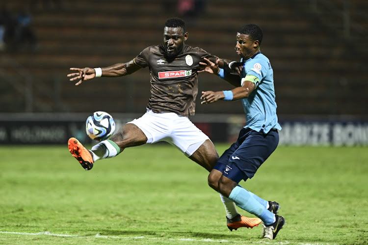 Junior Dion of AmaZulu puts his best foot forward while Richards Bay captain Sibusiso Mthethwa tries to out-muscle him during their DStv Premiership match at King Goodwill Zwelithini Stadium on Tuesday.