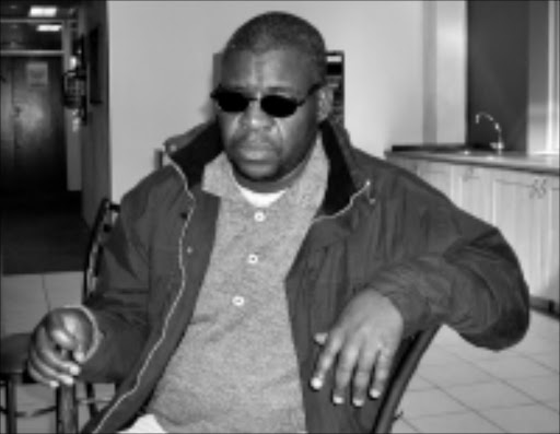 HURT: April Rapeiwa is being booted out of the block of flats he has looked after for 12 years even though he was blinded on the property. Pic. Penwell Dlamini. 07/2008. Sowetan.