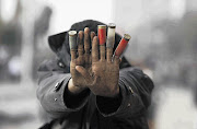 A protester against Egypt's President Mohamed Morsi displays expended shotgun cartridges that he said were fired by riot police during clashes along Qasr al-Nil Bridge, which leads to Tahrir Square, Cairo.