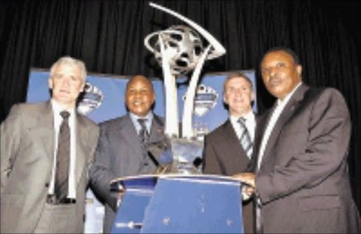 COMBATANTS: Officials of the clubs will take part in the Vodacom Challenge pose with trophy during the launch yesterday, from left, Manchester City coach Mark Hughes, Kaizer Chiefs boss Kaizer Motaung, City's executive chairman Garry Cook and Orlando Pirates chairman Irvin Khoza. 04/05/09. Pic. Veli Nhlapo. © Sowetan.