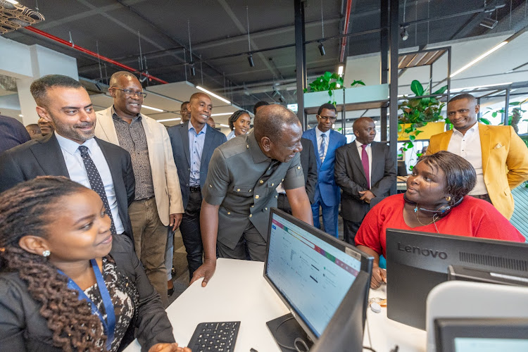President William Ruto shakes interacts with a staff at the Call Centre International(CCI) Global Contact Centre, Tatu City, Kiambu County during its launch on May 10, 2024.