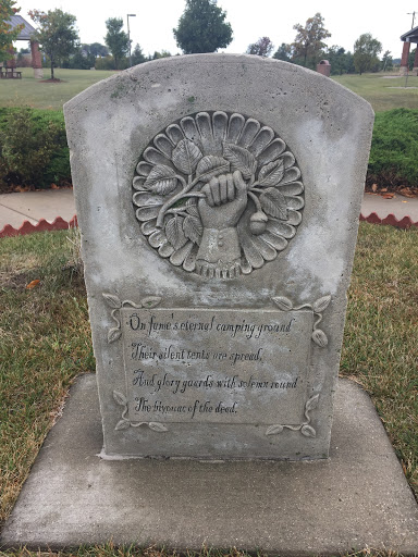 A memorial at Dows Rest Area in Iowa. It reads:  "On fame's eternal camping ground, Their silent tents are spread And glory guards with solemn spread The bivouac of the dead."