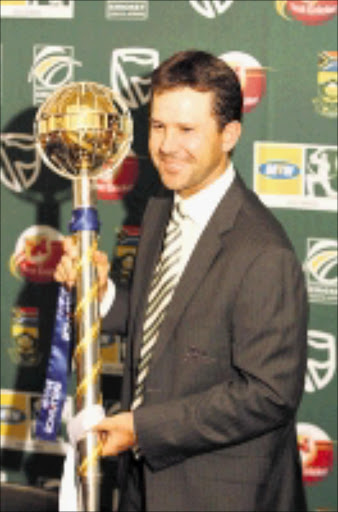 COME AND GET IT: Ricky Ponting holds up the Test champions trophy during the Australian cricket team's press conference yesterday. 16/02/09. Pic. Bafana Mahlangu. © Sowetan.