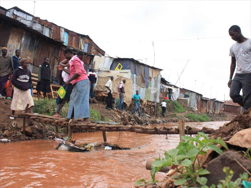 Residents cross the Mathare River