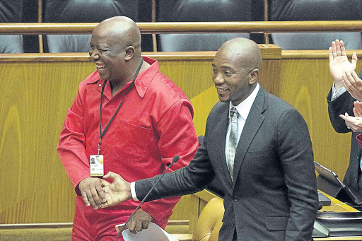 MAKING A POINT: EFF leader Julius Malema, left, and DA leader Mmusi Maimane shake hands in parliament Picture: TREVOR SAMSON