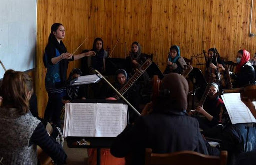 In this January 8, 2017 photo, Negina Khpalwak, the first female orchestra conductor in Afghanistan, is seen during a rehearsal at the National Institute of Music in Kabul.