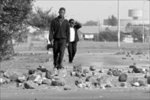 DEFIANT: Roads into Khutsong township in North West remained blocked with rocks yesterday after a protest by pupils who are boycotting classes. Pic. Peter Mogaki. 19/04/07. © Sowetan.