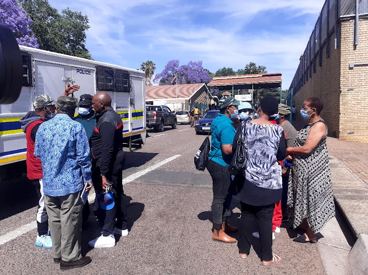 A group of people who identified themselves as military veterans outside the Kgosi Mampuru prison, where suspects are due to appear on charges related to the recent 'hostage' situation involving two cabinet ministers.