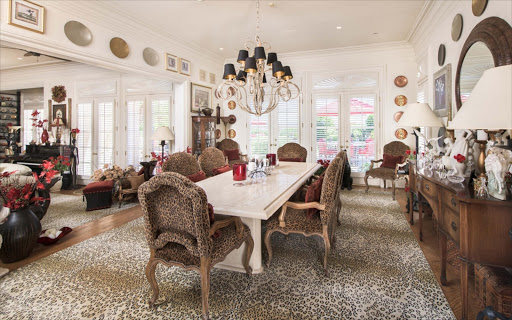 There are unusual patterns in the animal print dining room.