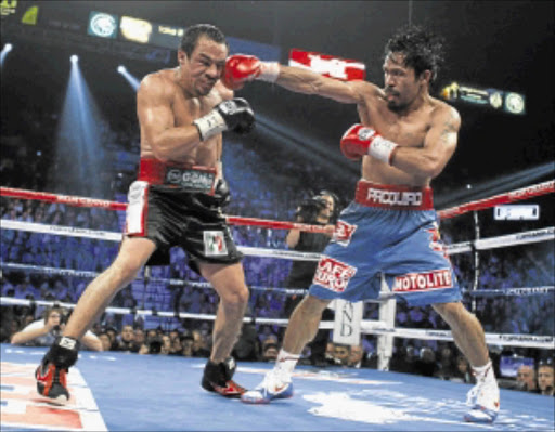 TOUGH: Juan Manuel Marquez (L) of Mexico fights against Manny Pacquiao of the Philippines during their WBO welterweight bout at the MGM Grand Garden Arena in Las Vegas yesterday. PHOTO: REUTERS