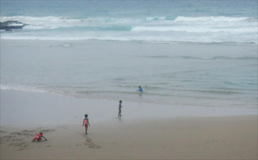 DAREDEVILS: Four young children swimming at the notorious Second Beach in Port St Johns just a day after two beachgoers drowned and two sharks spotted in the waters by authorities.Picture: SIKHO NTSHOBANE