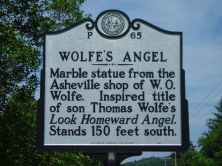 Marble statue from the Asheville shop of W. O. Wolfe. Inspired title of son Thomas Wolfe's Look Homeward Angel. Stands 150 feet south.Plaque via North Carolina Highway Historical Marker Program,...